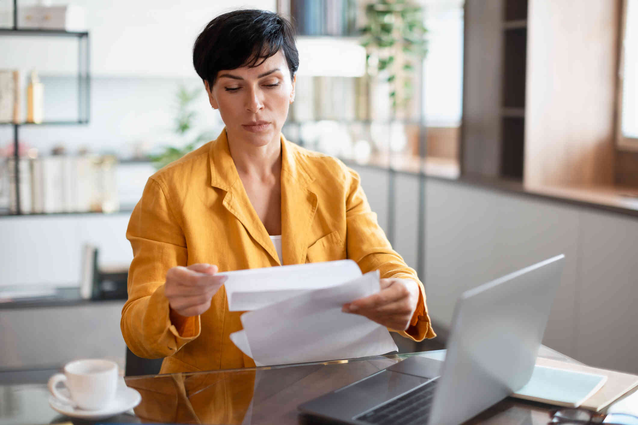 A woman goes through some papers.