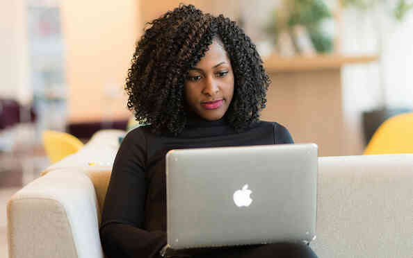 woman looking at macbook