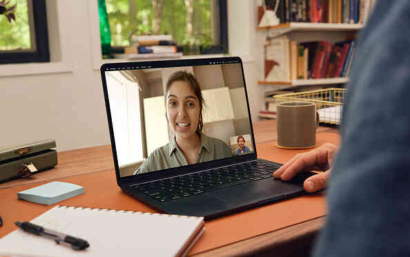 video chatting with female therapist on laptop